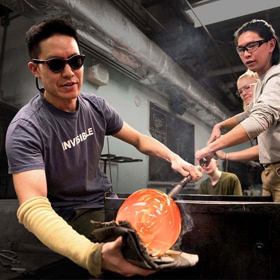 Glass blowers at work in a VCU School of the Arts studio.