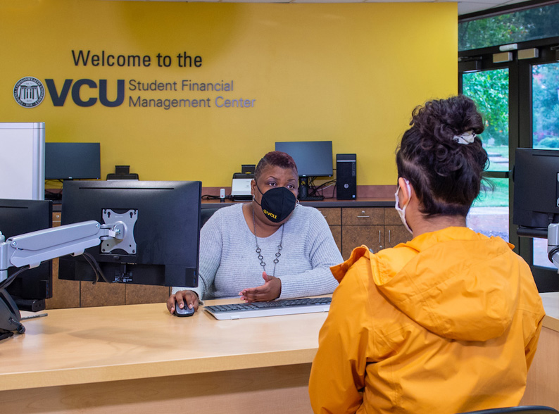 Two people talking at the VCU Student Financial Management Center