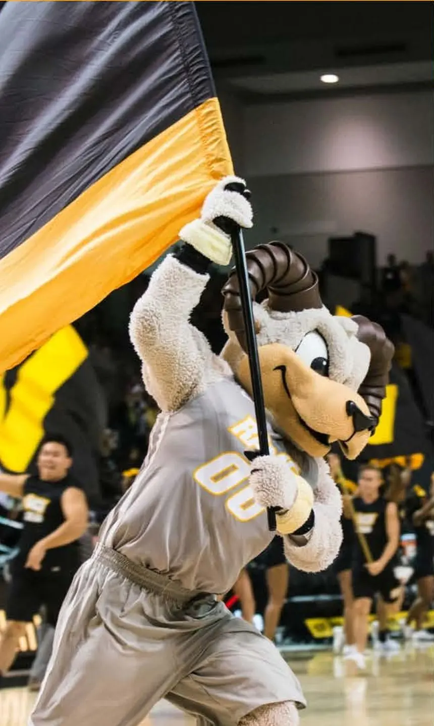Rodney storming the VCU basketball court with a VCU themed flag